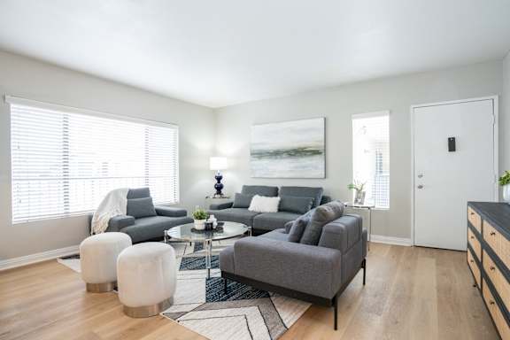 a living room with a couch and a chair and a table