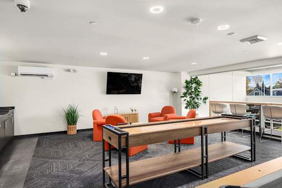 A conference room with a long table and chairs.