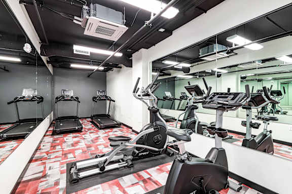 A gym with treadmills and exercise bikes.