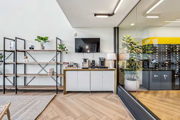 A modern kitchen with a wooden floor and white cabinets.