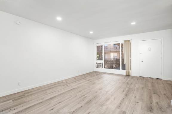 A room with wooden flooring and white walls.at Palms at Menlo, California, 90006