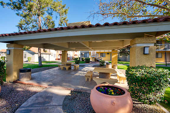A patio area with a large planter in the center.