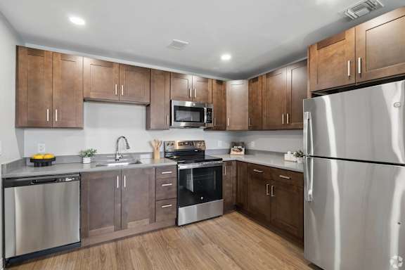 A kitchen with wooden cabinets and stainless steel appliances.