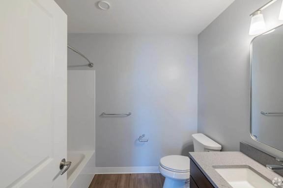 A white toilet sits next to a sink in a small bathroom.