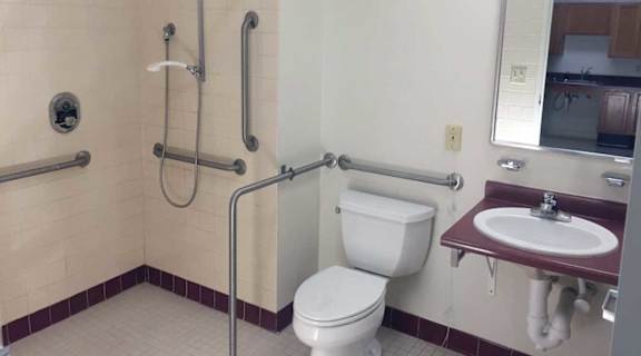 A bathroom with a toilet, sink, and shower.