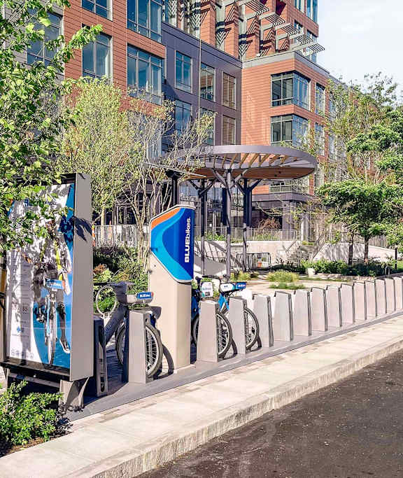 A bike sharing station with bikes parked and a sign that says "BikeShare".
