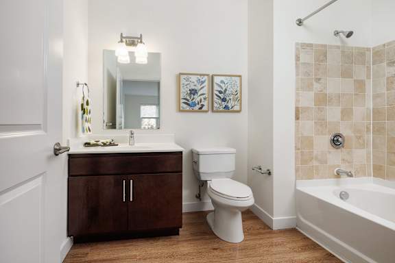 A white toilet sits next to a sink in a bathroom.
