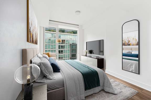 A modern bedroom with a large bed and a flat screen TV.