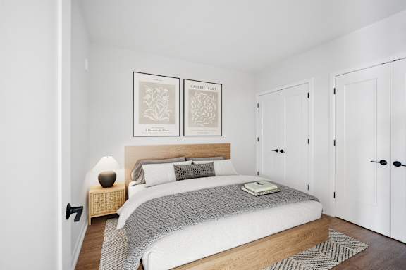 a bedroom with a bed and two white closets