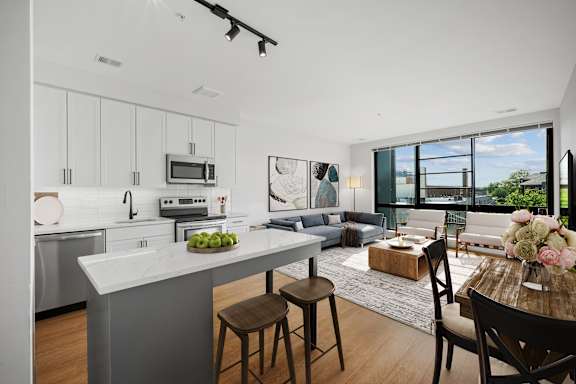 an open living room with a kitchen and a dining room
