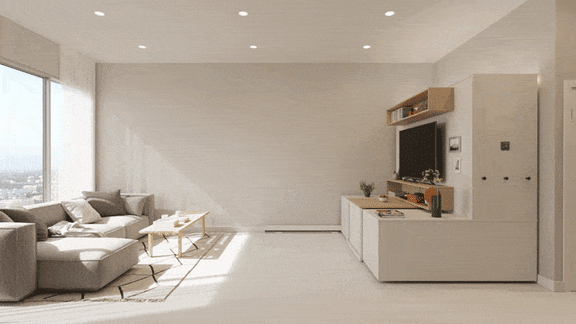 A modern living room with a grey couch, a wooden coffee table, and a white cabinet with a TV on top.
