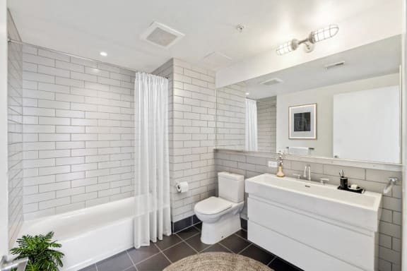 a white bathroom with a toilet and a sink