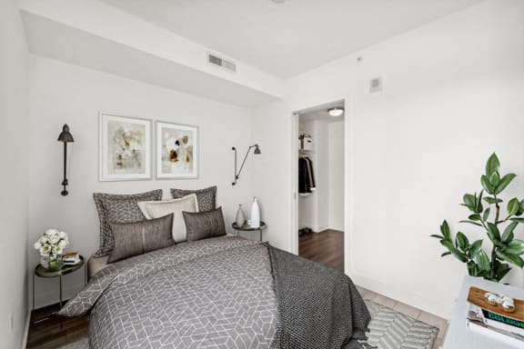 a bedroom with a bed and two pictures on the wall
