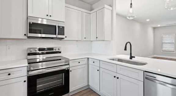 A room with wooden flooring and white walls. at Ovation at Town Madison, Alabama, 35758