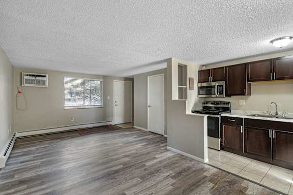 A kitchen with a stove top oven and microwave.