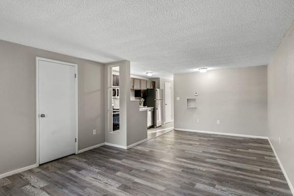 A room with a white door and a wooden floor.