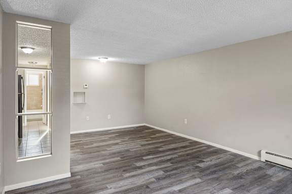 A room with a grey floor and a white door.