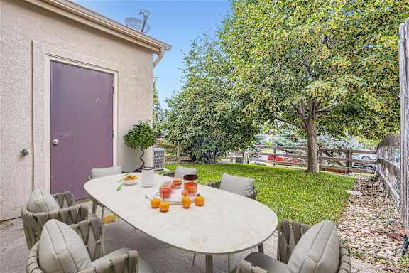A table with chairs and oranges on it.