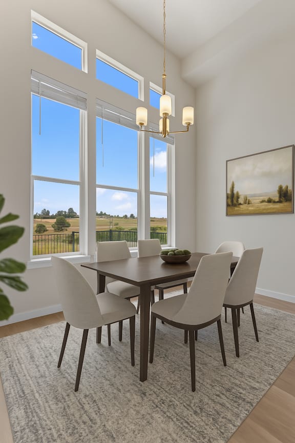 A dining room with a table and chairs.