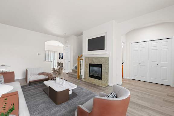 A living room with a fireplace and a television.