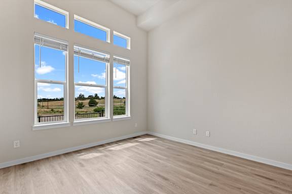 A room with a large window overlooking a landscape.
