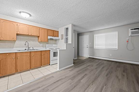 A kitchen with wooden cabinets and a white countertop.