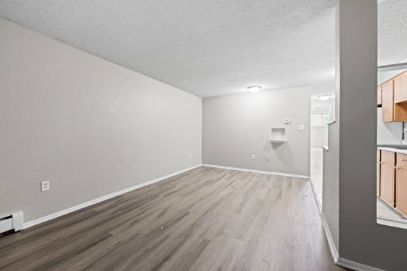 A room with wooden flooring and a white ceiling.