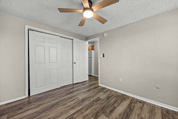 A room with a ceiling fan and a door.