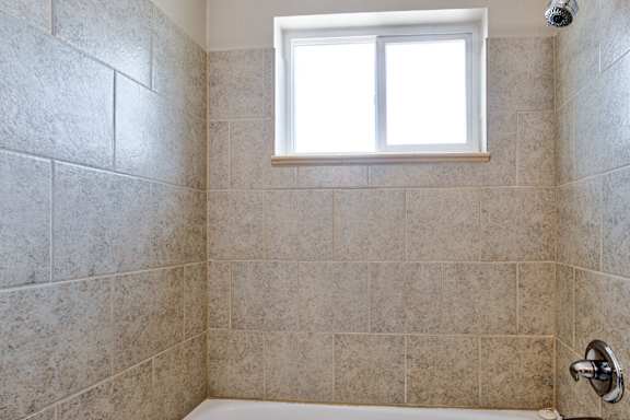 bathroom with window at Kingsbrook Arms, Englewood, Co 80113