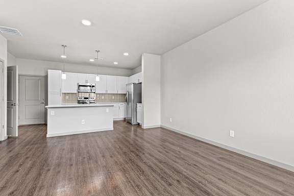 Living room and kitchen with wood flooring at The Point at Biscay, Aurora