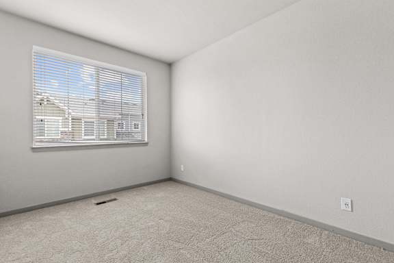 Bedroom with a large window at The Point at Biscay, Aurora, CO