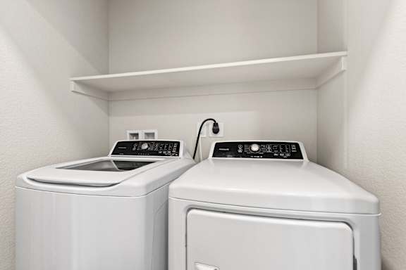Laundry room has two washes and a dryer at The Point at Biscay, Aurora
