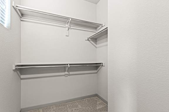 Spacious walk in closet with a white wall and a sliding glass door at The Point at Biscay, Aurora
