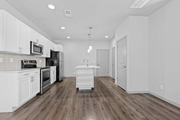 Living room and kitchen with wood flooring at The Point at Biscay, Aurora