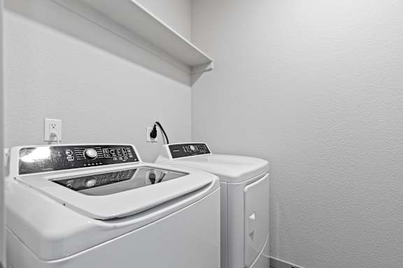Washer and dryer in a laundry room at The Point at Biscay, Aurora, CO, Colorado
