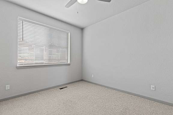 Bedroom with a window and a ceiling fan at The Point at Biscay, Aurora, CO, 80013