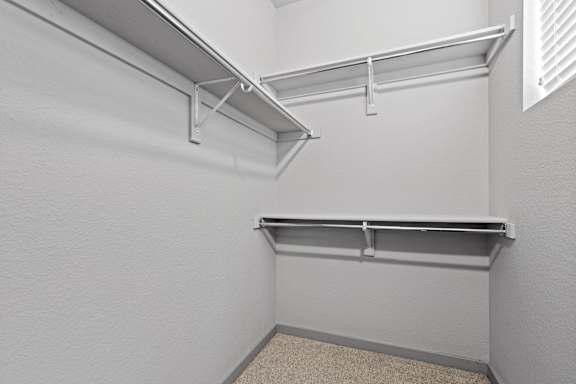Spacious walk in closet with shelves and hangers at The Point at Biscay, Aurora, CO, Colorado, 80013