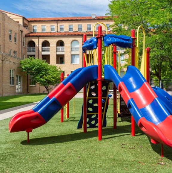 A red and blue slide in a playground.
