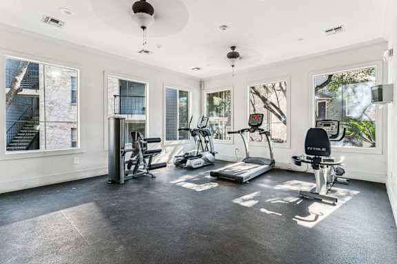 A spacious home gym with a variety of exercise equipment.