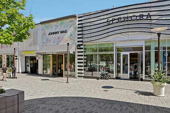 A Sephora store is located next to a Johnny WAS store.