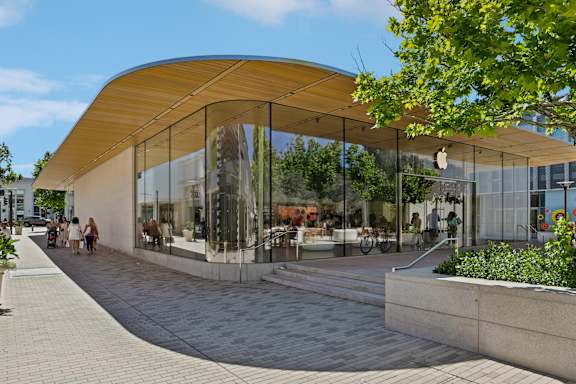 A modern building with a curved glass facade and a wooden roof.