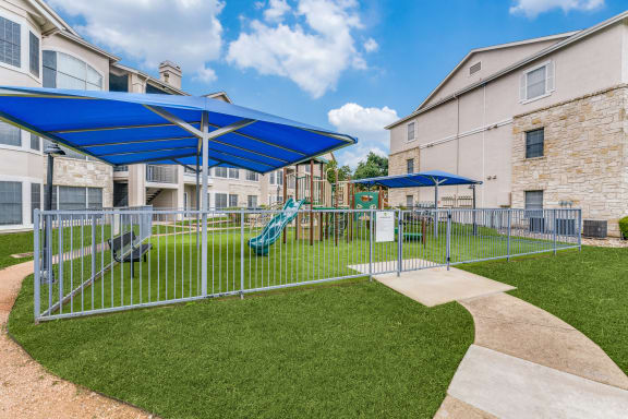 our apartments have a playground and picnic area with umbrellas