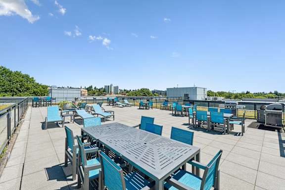 A large table surrounded by chairs on a patio.