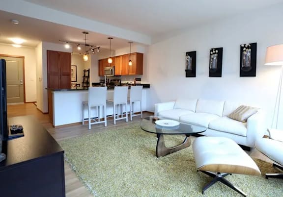 A modern living room with a white couch and a coffee table.
