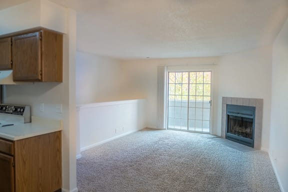 A living room with a fireplace and a window.