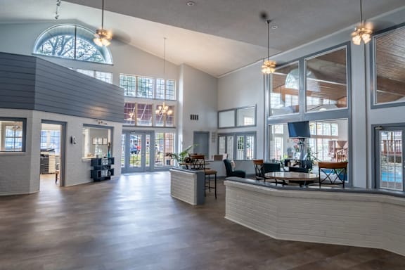 A spacious interior of a building with a curved ceiling and large windows.