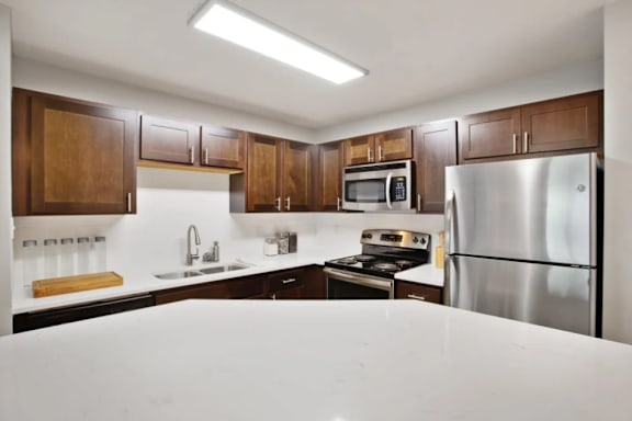 A kitchen with wooden cabinets and stainless steel appliances.