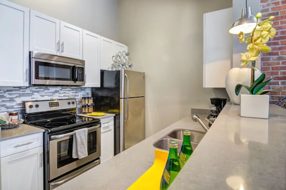 A kitchen with a white counter top and a yellow line painted on it.