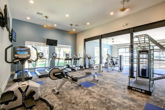 A gym with treadmills and exercise bikes.