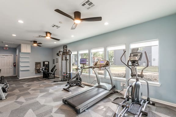 A spacious home gym with a variety of exercise equipment.